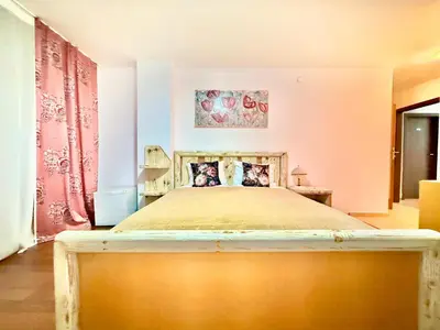 a bedroom with a large bed in a room at Family Hotel Carpe Diem in Banya