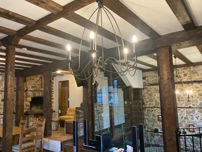 a chandelier hanging from a ceiling in a room at Къща Александрова с басейн вътрешен и отопляем in Arda