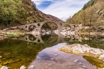an old bridge over a river in a canyon at Loft Apartment with a great view of Ardino in Ardino