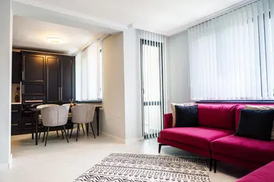 a living room with a red couch and a table at Loft Apartment with a great view of Ardino in Ardino