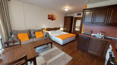 a living room with a bed and a couch at Сладко студио в Пирин с голф и СПА комплекс in Razlog