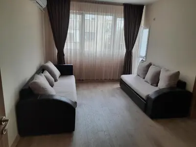 a living room with two leather couches and a window at Sandanski city center apartment in Sandanski