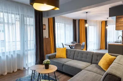 a living room with a couch and a table at Апартаменти 22 in Velingrad