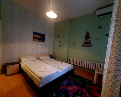 a bedroom with a bed in a room at Hotello in Sofia