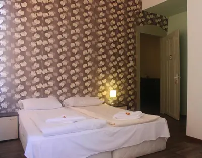 a bedroom with a bed with two towels on it at Hotello in Sofia
