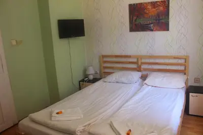 a bedroom with a bed with two towels on it at Hotello in Sofia