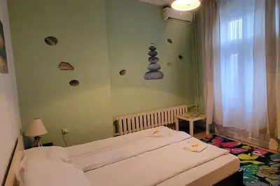 a bedroom with two beds and rocks on the wall at Hotello in Sofia