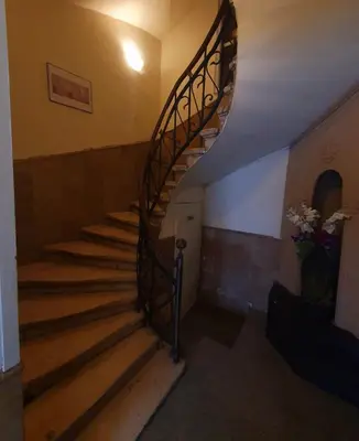 a spiral staircase in a building with flowers on it at Hotello in Sofia