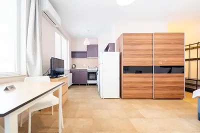 a kitchen with a white refrigerator in a room at Lovely apartment in Studentski grad in Sofia