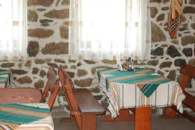 a dining room with two tables and a window at Хотел Варненци in Lŭki