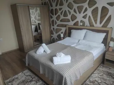 a bedroom with a bed with two towels on it at Апартамент Четири сезона 2 in Velingrad