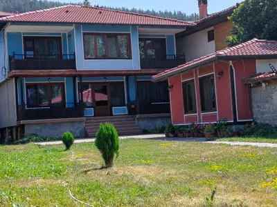 a house with a lawn in front of it at Къща Ради in Koprivshtitsa