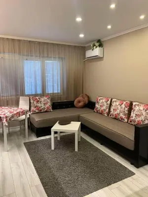 a living room with a couch and a table at Harmony Centrally Located Studio in Sofia