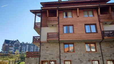 a wooden building with balconies on the side of it at Free SPA в Св. Иван Рилски - Сладък дом сред лукс in Bansko
