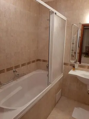 a bathroom with a tub and a sink at Free SPA в Св. Иван Рилски - Сладък дом сред лукс in Bansko