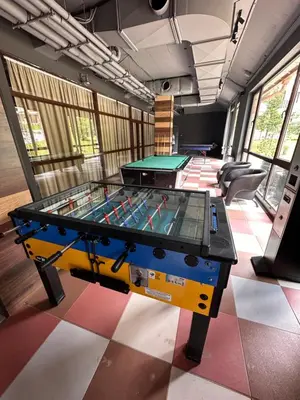 a ping pong table in the middle of a room at Petkovi Аpartments, Borovets Gardens - One-bedroom and Two-bedroom apartments in Borovets