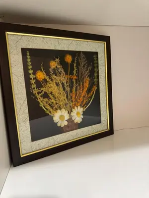 a picture of a vase of flowers on a wall at Луксозен апартамент в сърцето на Сандански in Sandanski