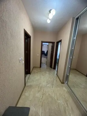 an empty hallway of a house with doors and tile floors at Луксозен апартамент в сърцето на Сандански in Sandanski