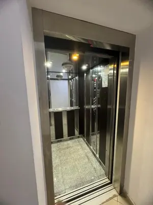 a glass door to a elevator in a building at Луксозен апартамент в сърцето на Сандански in Sandanski