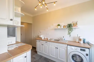 a kitchen with a washer and dryer and a staircase at Sunrise 1BDRM View Apartment NDK Congress Centre in Sofia