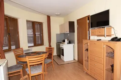 a kitchen and dining room with a table and chairs at ЗАМЪКА 1 in Pamporovo