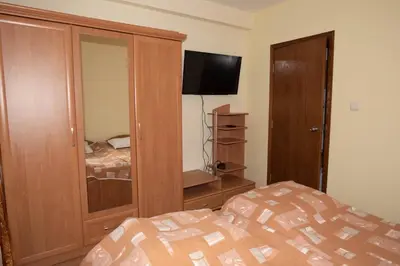 a bedroom with a bed and a cabinet with a television at ЗАМЪКА 1 in Pamporovo