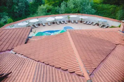 an overhead view of a roof with chairs and a pool at Family Hotel Shipkovo in Shipkovo