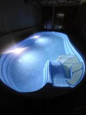 a swimming pool with a light in the middle at Family Hotel Shipkovo in Shipkovo