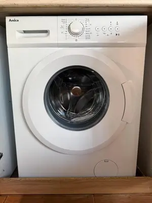 a white washing machine sitting in a room at Georgievi Apartments Sandanski in Sandanski