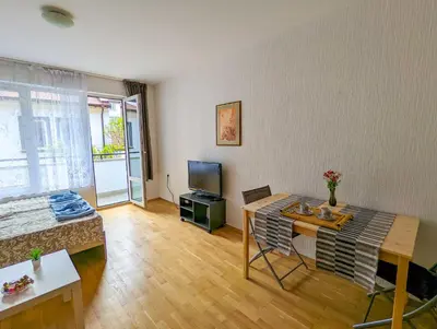 a living room with a table and a tv at Top Center Relax, NDK & Vitoshka & Metro station in Sofia