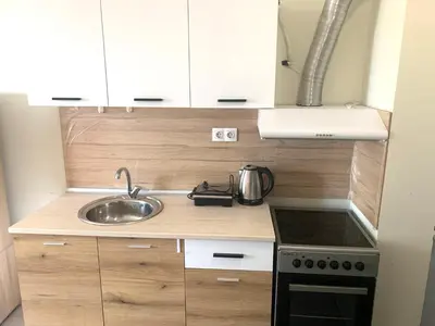 a small kitchen with a sink and a stove at City Residence Apartments Sofia in Sofia