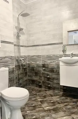 a bathroom with a toilet and a sink and a shower at City Residence Apartments Sofia in Sofia