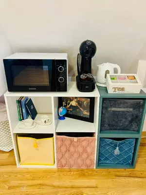 a microwave on top of a white shelf at Minimalist Apartment in Sofia