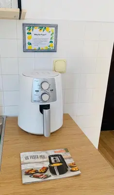 a toaster sitting on a counter next to a magazine at Minimalist Apartment in Sofia