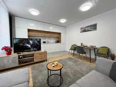 a living room with a couch and a tv at CityApartment in Sofia