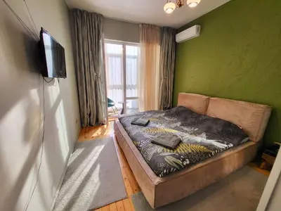 a bedroom with a bed and a television in it at The Best Place in the heart of Sofia City center in Sofia