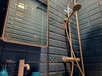 a shower in a bathroom with blue tiled walls at The Best Place in the heart of Sofia City center in Sofia