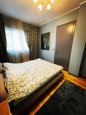 a bedroom with a bed and a window and a door at The Best Place in the heart of Sofia City center in Sofia