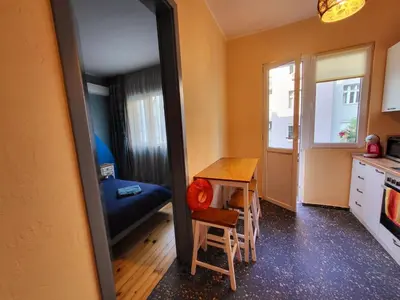 a room with a table and a bed and a mirror at The Best Place in the heart of Sofia City center in Sofia