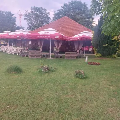 a group of tables and umbrellas in a yard at Комплекс Александьр между Банско и село Бяня in Bansko