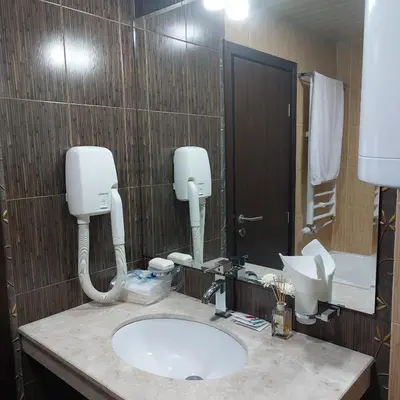 a bathroom with a sink and a mirror at Комплекс Александьр между Банско и село Бяня in Bansko