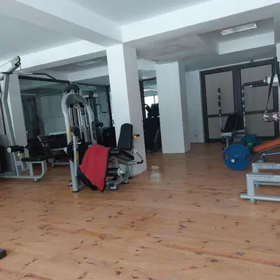 a gym with treadmills and exercise equipment in a room at Комплекс Александьр между Банско и село Бяня in Bansko