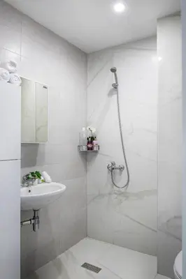 a white bathroom with a shower and a sink at Free Parking On Premises Huge Terrace in Sofia