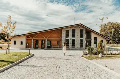 a woman standing in front of a building at 7 Lakes camping in Sapareva Banya