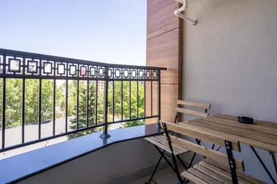 a balcony with a wooden bench and a window at Amarant Aparts in Sofia