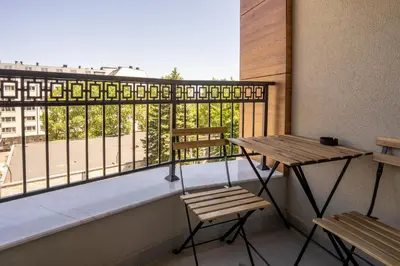 a balcony with a table and two chairs and a view at Amarant Aparts in Sofia