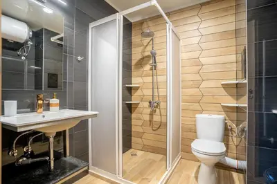 a bathroom with a shower and a toilet and a sink at Amarant Aparts in Sofia
