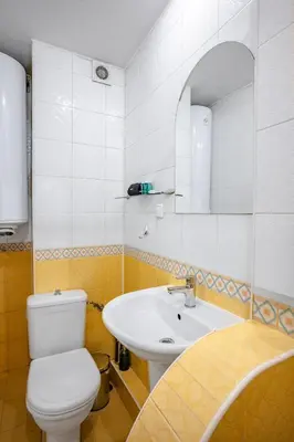 a bathroom with a white toilet and a sink at Charming Studio on Vitosha Street by Flat Mаnager in Sofia
