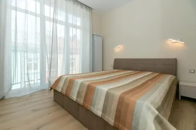 a bedroom with a bed and a large window at Луксозни студия “Старият Батак” / Luxury studios “The Old Batak” in Batak