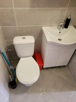 a bathroom with a white toilet and a sink at Къща Чолаков и син - стаи за гости in Devin
